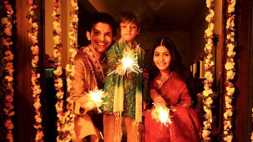 Woman lighting Diwali Diya